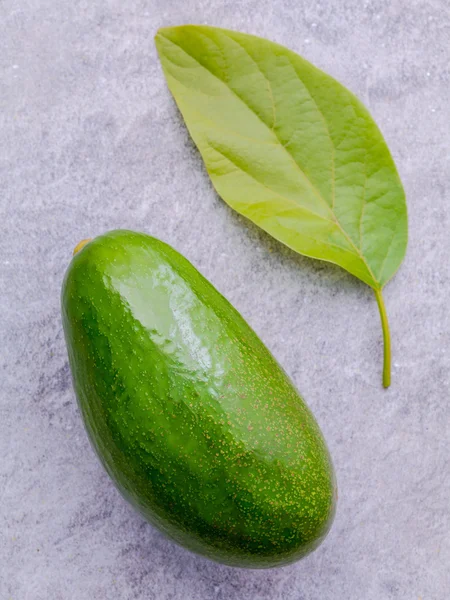 Fresh avocado on stone background. Organic avocado healthy food — Stock Fotó