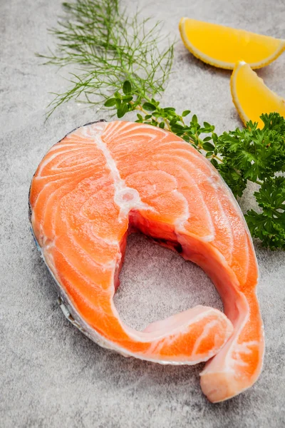 Tranche de filet de saumon frais sur fond de pierre sombre avec fenouil a — Photo