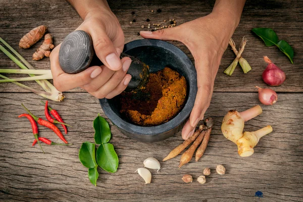 The Women hold pestle with mortar and spice red curry paste ingr — Stock Photo, Image