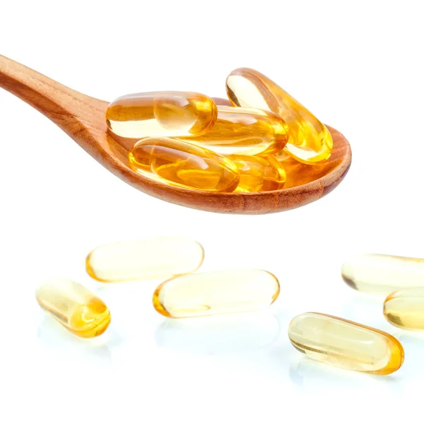 Spoonful of gel capsules of omega 3. Close up capsules fish oil — Stock Photo, Image