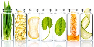 Homemade skin care with natural ingredients and herbs in glass bottles isolate on white background.