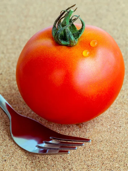 The giant red tomato with fork. - Healthy food concept. — Stock Photo, Image