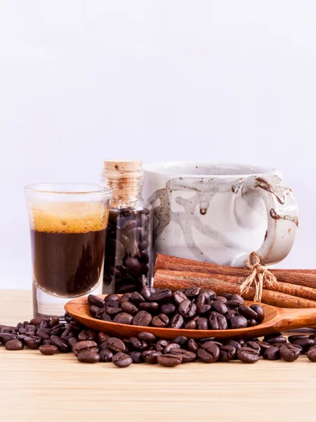 A Coffee cup and coffee beans on  wooden panel - With copy space — Stock Photo, Image