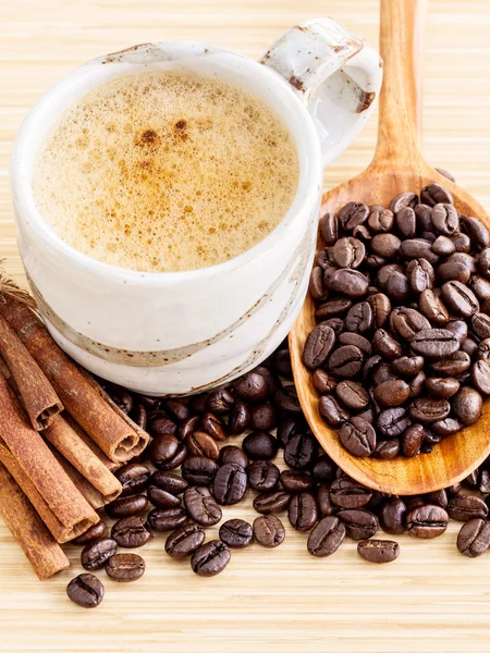 A Coffee cup and coffee beans on  wooden panel - With copy space — Stock Photo, Image