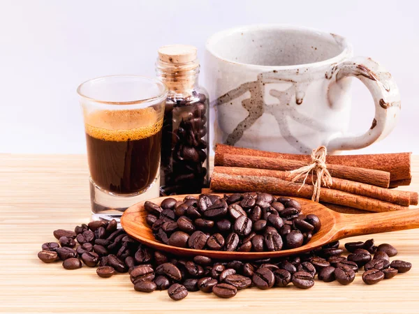 A Coffee cup and coffee beans on  wooden panel - With copy space — Stock Photo, Image