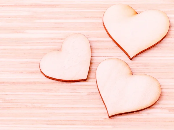 The wooden hearts on wooden background. - Concept for love and w — Stock Photo, Image