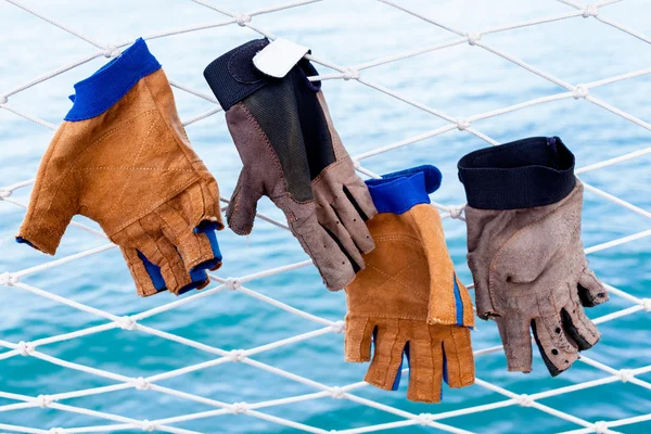 Sailing glove hanging on the nets  of sailing yacht. — Stock Photo, Image