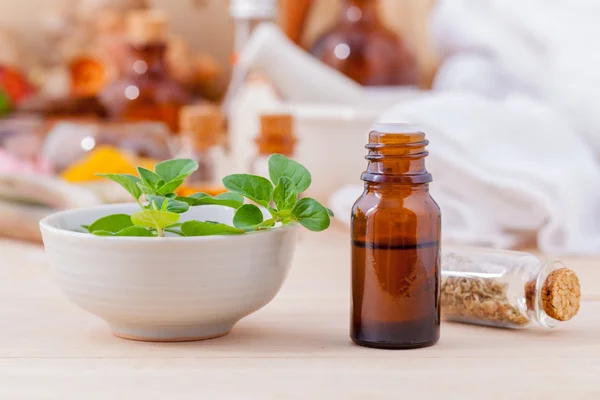 Natural Spa Ingredients essential oil with oregano leaves for ar — Stock Photo, Image