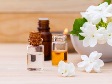 Ahşap backgr Yasemin çiçekleri ile düzenlenmiş aroma yağ şişeleri