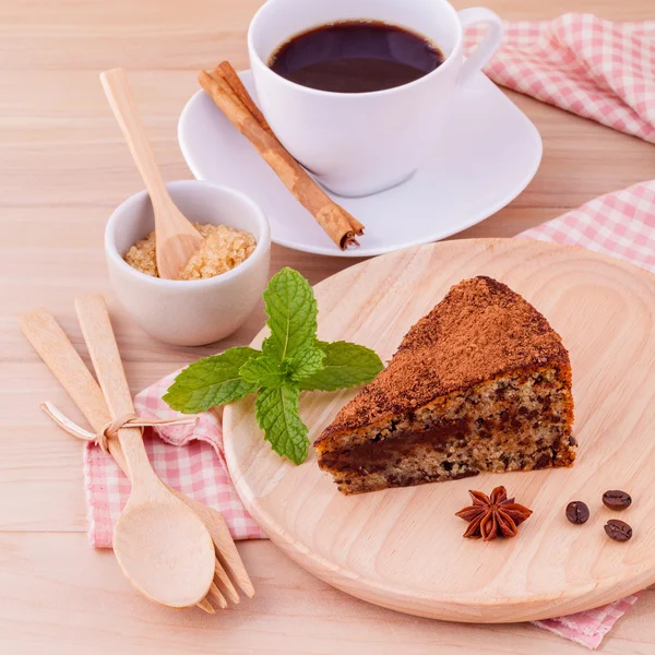 Homemade dark chocolate cake with cup of coffee on wooden backgr — Stock Photo, Image