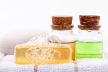 Beyaz banyo havlusu üzerine bitkisel spa sabun çubuğu .