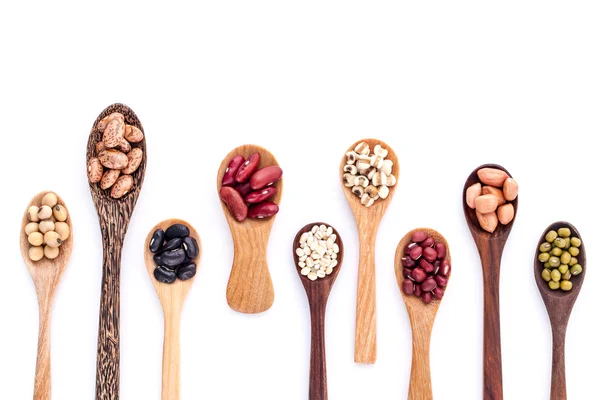 Assortment of beans and lentils in wooden spoon isolate on white — Stock Photo, Image