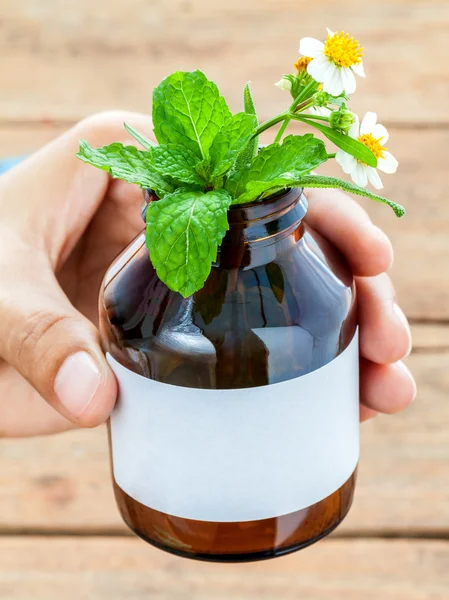 Doctor holding alternative health care fresh herbal in bottle wi — ストック写真