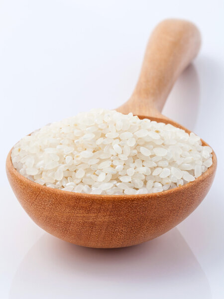 Japanese rice, the short rice used for sushi in wooden spoon wit