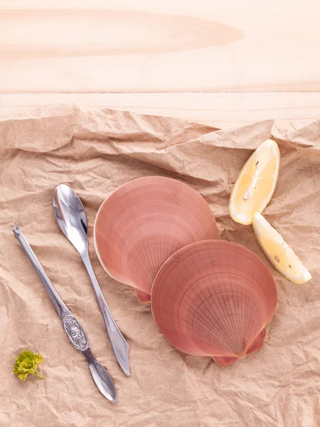 Raw queen scallops with lemon slice ,fork and spoon preparing fo — Zdjęcie stockowe