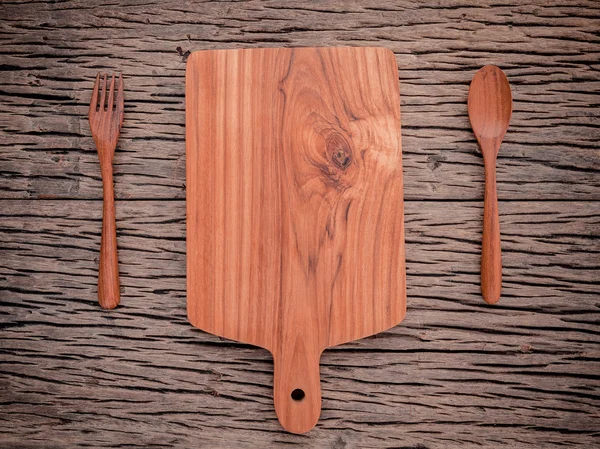 Empty vintage Teak wood cutting board ,fork and spoon on grunge — Stok fotoğraf