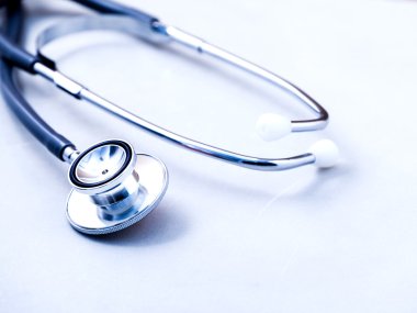 Stethoscope on white table with shallow depth of field for medic