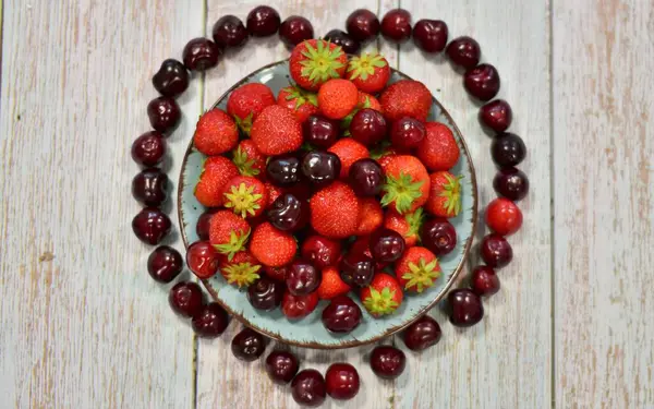 Reife Erdbeeren Und Kirschen Auf Einem Hölzernen Hintergrund — Stockfoto