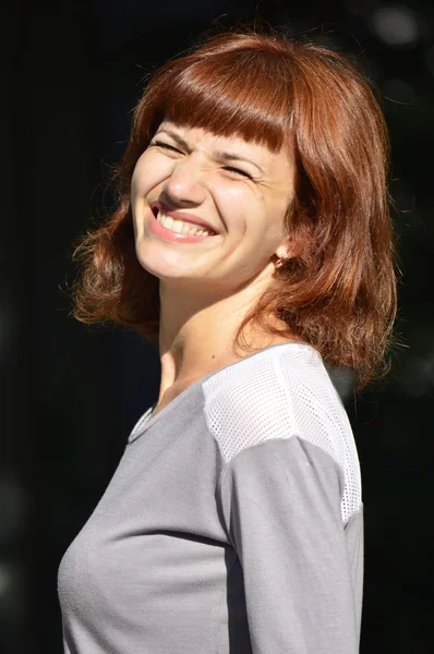 woman squinting and smiling