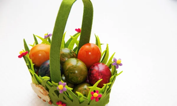 Painted eggs in the basket — Stock Photo, Image