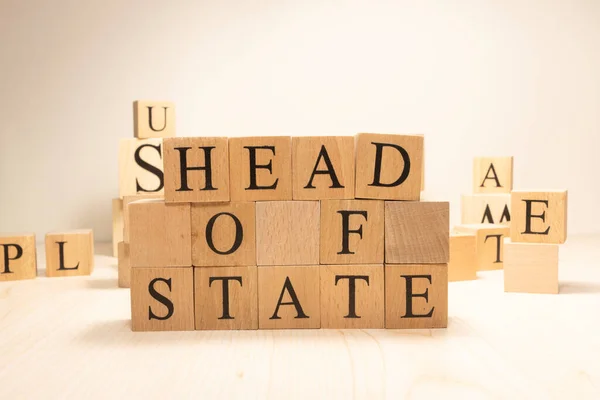 The word house of state is from wooden cubes. Terms of economy state government. Background made of wooden letters.