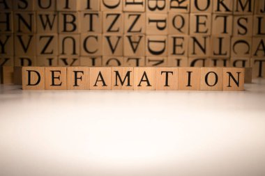 The word defamation end was created from wooden cubes. Countries and politics, people. Close up. clipart