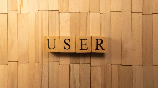 The word user friendly was created from wooden cubes. Technology and life. close up.