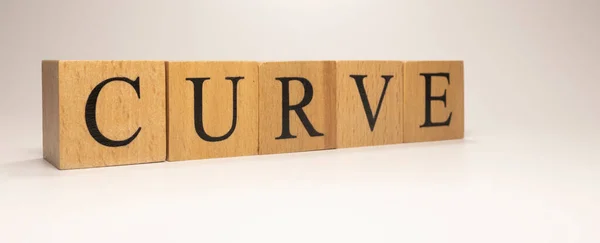 The name Curve was created from wooden letter cubes. Economics and finance. close up.