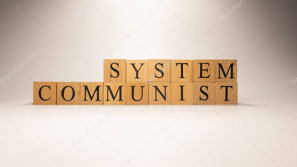 The name Communist system was created from wooden letter cubes. Economics and Finance. close up.