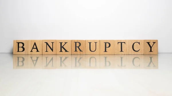 The name Bankruptcy was created from wooden letter cubes. finance and illegal. — Stock Photo, Image