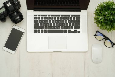 Üzerinde bilgisayar cihazları, akıllı telefon, ofis malzemeleri ve kahve olan masa başı çalışma masasının fotokopi alanı olan en iyi manzara. Düz yatıyordu.