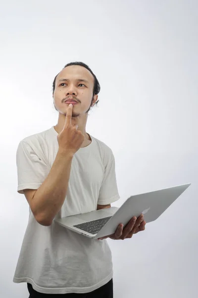 Portrait Young Man Thinking Holding Computer Isolated White — Stok fotoğraf