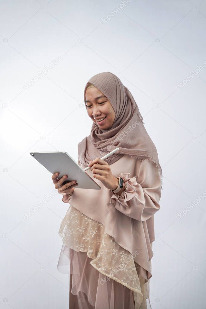 portrait of a young woman with hija holding a tablet computer  isolated in white