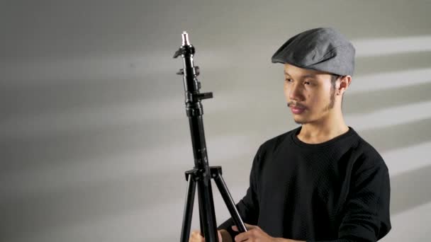 Young Asian Man Preparing Camera Tripod — Stock Video