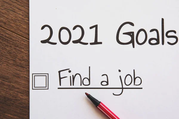 planner of goals and plans for 2021, a sheet of paper with the inscription find a job from to do list with a tick
