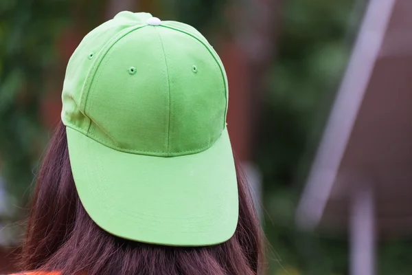 One girl with hair color ware green cap