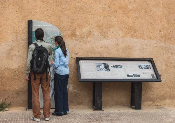 Two tourist read guiding map of Kasbah of the Udayas — Stock Photo, Image