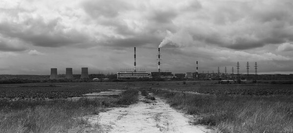 Image of factory in the middle of a meadow on a cloudy day