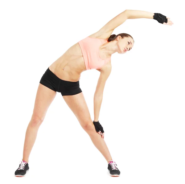 Vältränad kvinna stretching för att värma upp - isolerade över vit bakgrund — Stockfoto