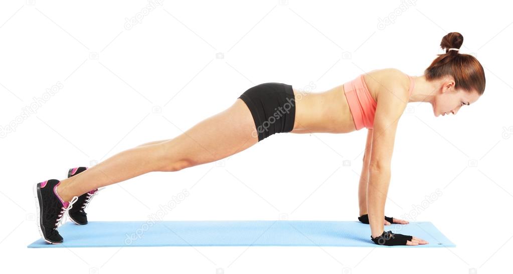 Fit woman doing push up exercise - isolated over white backgroun