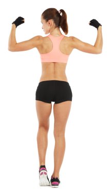 Whole length image of young sporty woman showing her biceps isol