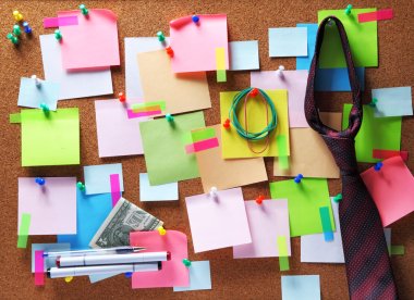 Image of colorful sticky notes on cork bulletin board clipart