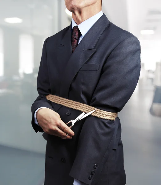 Image of businessman trying to get rid of fetters — Stock Photo, Image