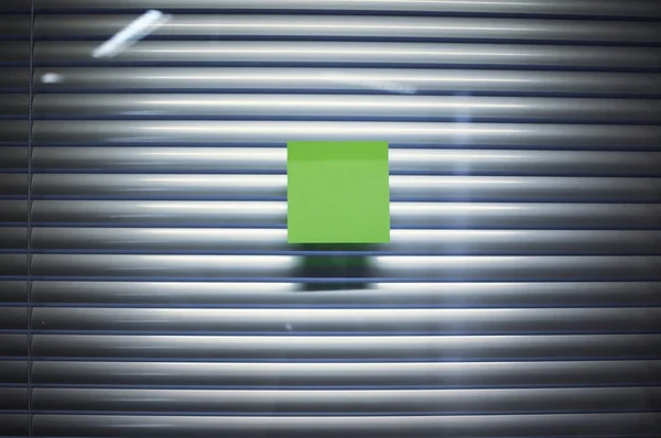 Image of blank sticky note on office glass wall with jalousie — Stock Photo, Image