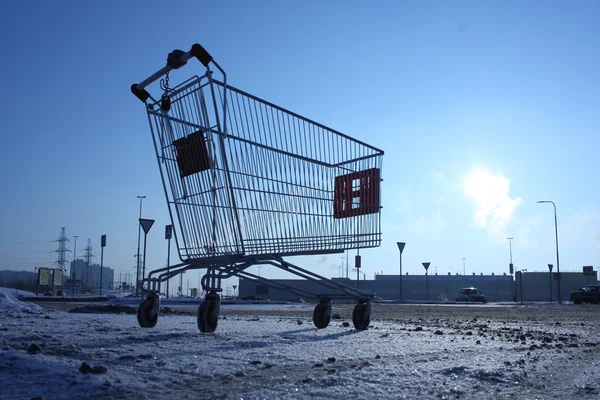 Image of empty shopping cart on empty parking near huge store — Stock Photo, Image