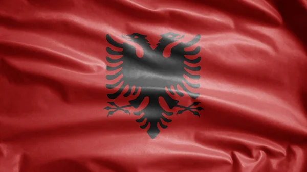 Albanian flag waving in the wind. Close up of Albania banner blowing, soft and smooth silk. Cloth fabric texture ensign background. Use it for national day and country occasions concept.