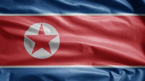 North Korean flag waving in the wind. Close up of Korea banner blowing, soft and smooth silk. Cloth fabric texture ensign background.