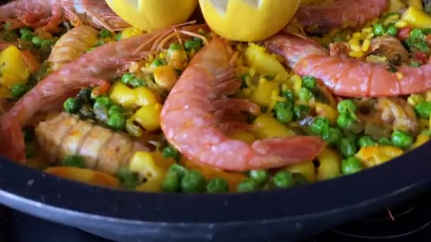 Chef Cooking Paella Bubbling Prawns Lemon Assorted Seafood Preparing Tipical — Stock Video
