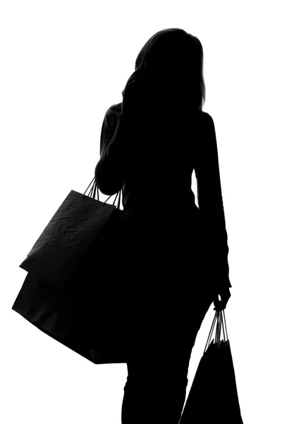 Sziluettjét, egy nő a bevásárló szatyrok — Stock Fotó