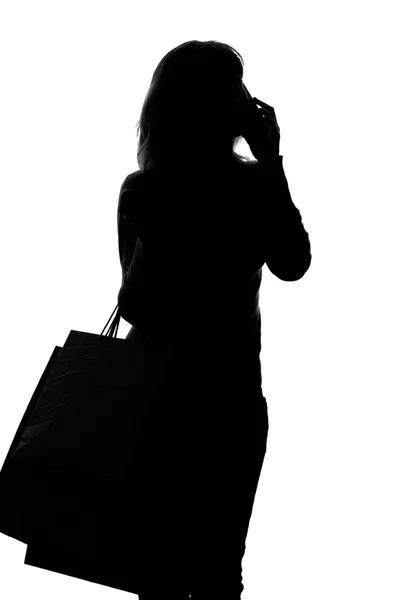 Silhouette di donna con shopping bag — Foto Stock